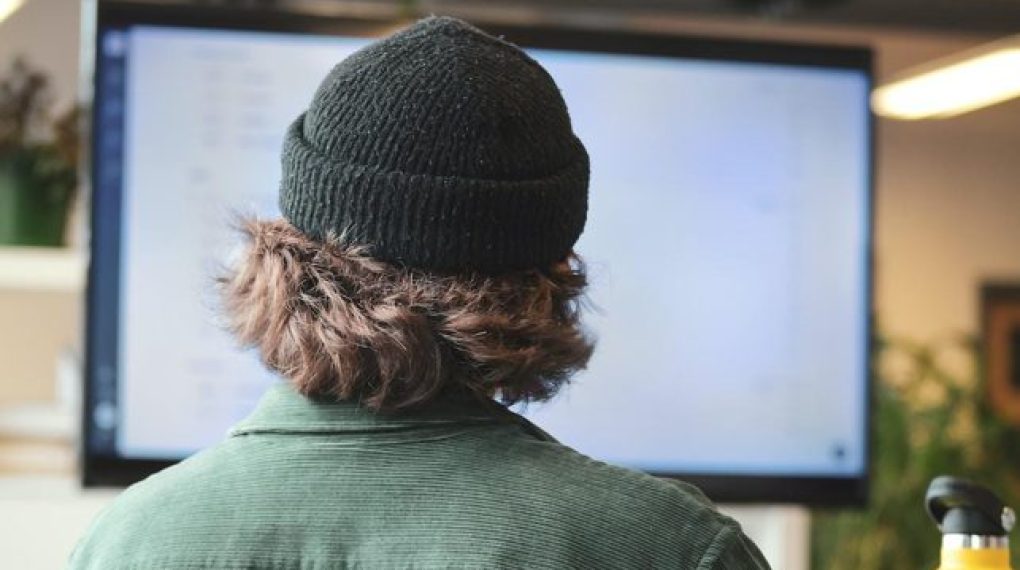Back of employee's head using computer desktop screen for intelligent search